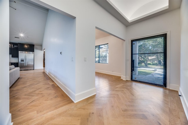 foyer with recessed lighting and baseboards