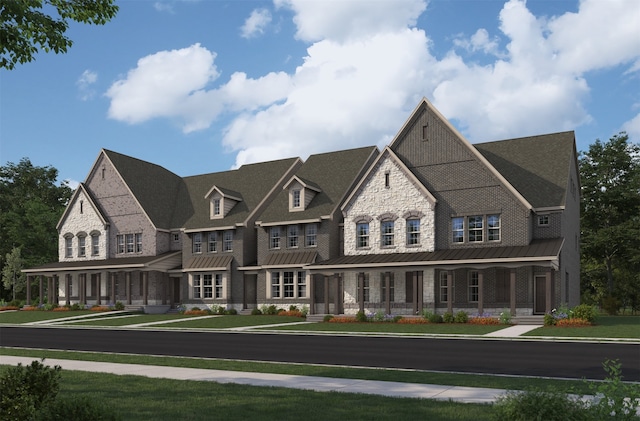 view of front of home with covered porch, metal roof, a front lawn, and a standing seam roof