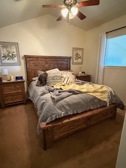 bedroom featuring a ceiling fan, lofted ceiling, and light colored carpet