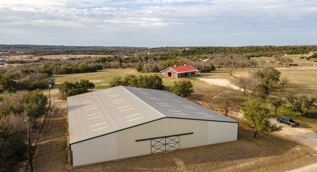 surrounding community with a rural view and an outbuilding