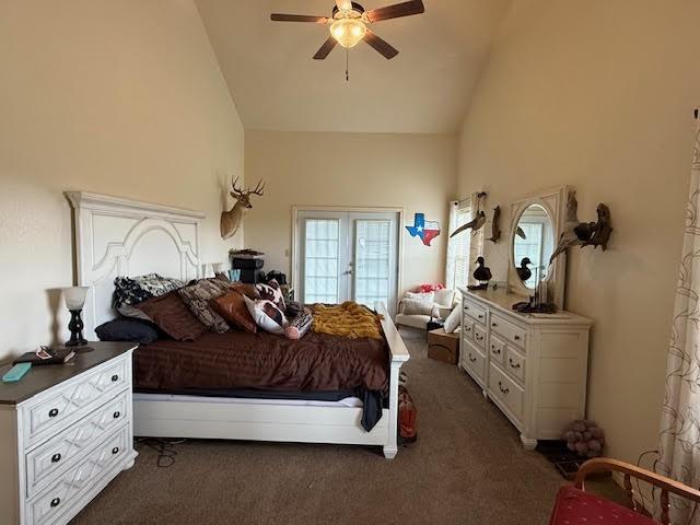 bedroom with high vaulted ceiling, ceiling fan, and dark carpet