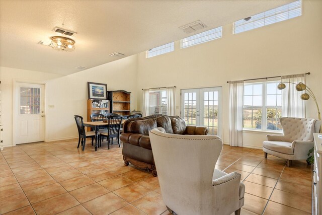 carpeted bedroom with high vaulted ceiling, access to exterior, and ceiling fan