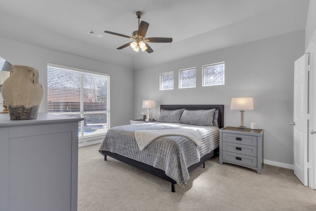 bedroom with light carpet, baseboards, visible vents, and a ceiling fan