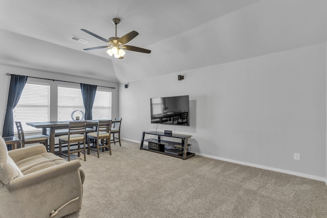 carpeted living room featuring lofted ceiling, visible vents, ceiling fan, and baseboards