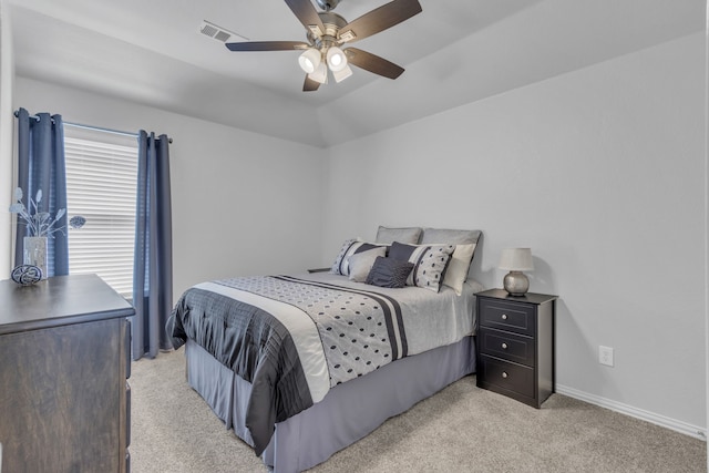 bedroom featuring light carpet, baseboards, visible vents, a ceiling fan, and lofted ceiling