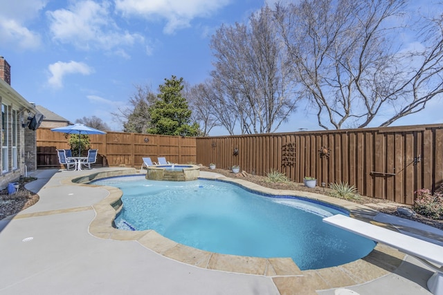 view of pool with a pool with connected hot tub, a fenced backyard, and a patio