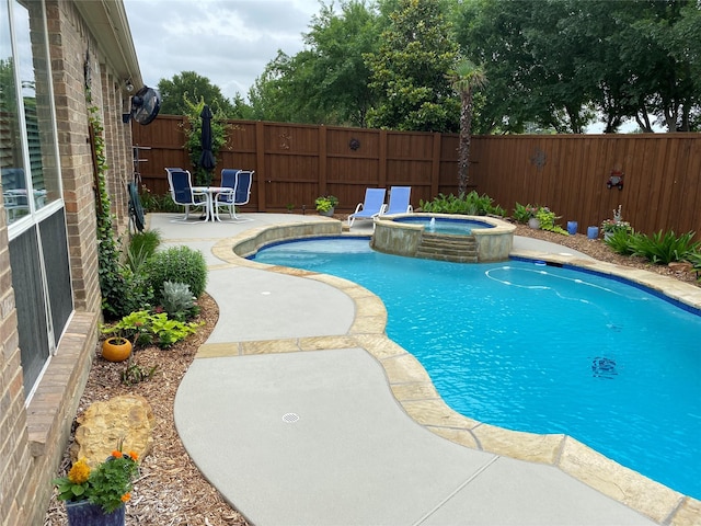 view of swimming pool with a pool with connected hot tub, a patio area, and a fenced backyard