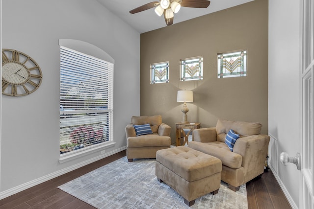 living area with ceiling fan, wood finished floors, and baseboards