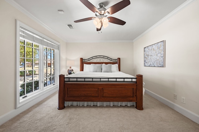 bedroom featuring light colored carpet, visible vents, crown molding, and baseboards