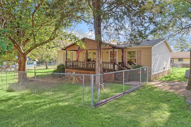 view of front of home with a gate, a fenced backyard, and a front lawn