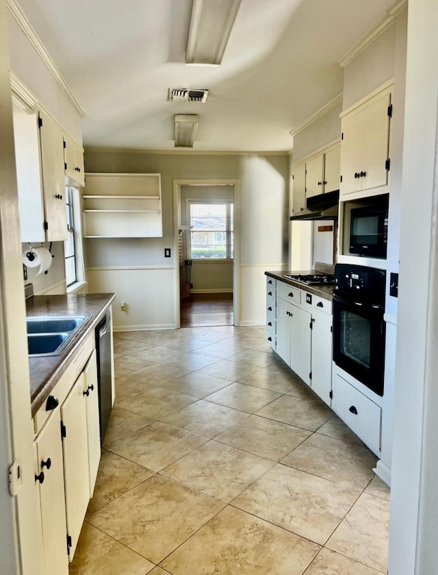 kitchen featuring crown molding, visible vents, a sink, and black appliances