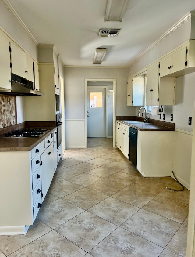 kitchen with dark countertops, visible vents, a sink, under cabinet range hood, and black appliances