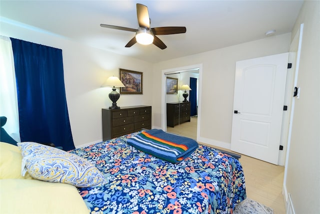 bedroom with a ceiling fan, a closet, and baseboards