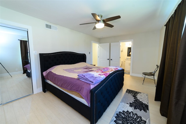 bedroom featuring light wood finished floors, visible vents, connected bathroom, ceiling fan, and baseboards