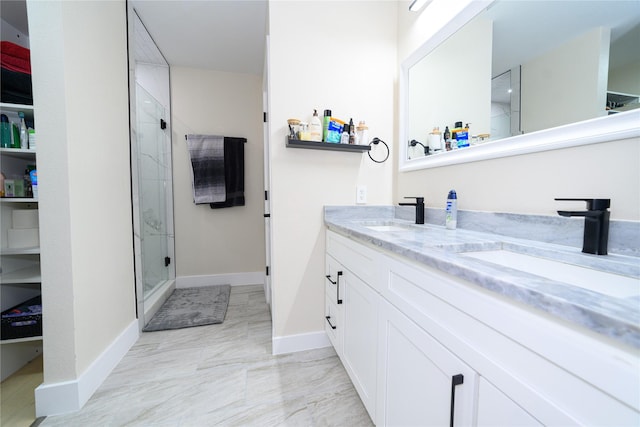 bathroom with marble finish floor, a sink, and a shower stall