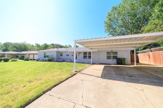 single story home with brick siding, driveway, a front lawn, and fence