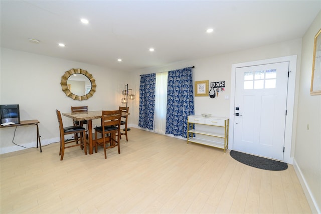 dining area featuring light wood finished floors, baseboards, and recessed lighting