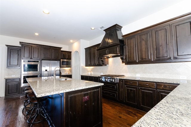 kitchen featuring arched walkways, appliances with stainless steel finishes, dark wood-style floors, and visible vents