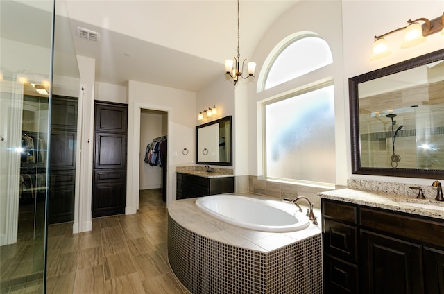 full bath with visible vents, a sink, tiled shower, and a bath