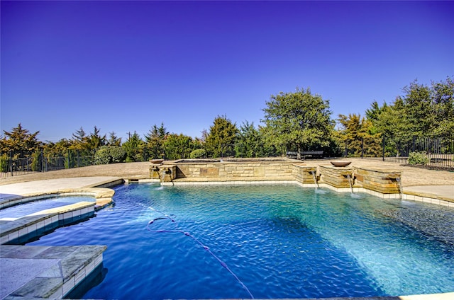 view of pool with a fenced in pool, an in ground hot tub, and fence