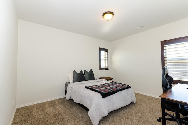 carpeted bedroom with baseboards and visible vents