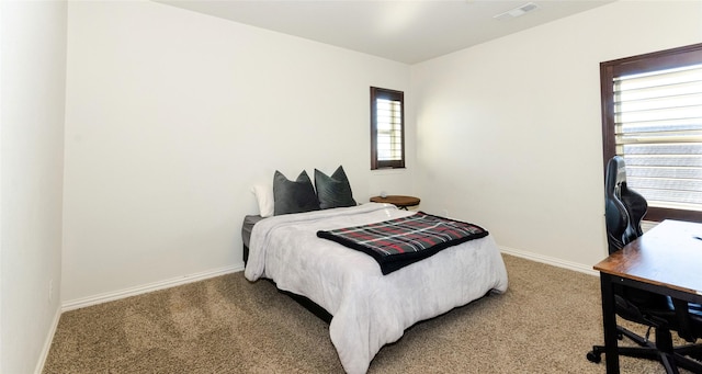 carpeted bedroom with baseboards and visible vents