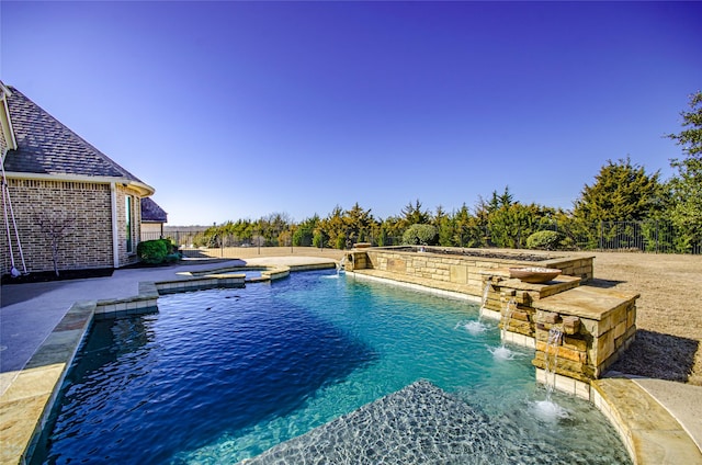 view of swimming pool featuring a pool with connected hot tub, a patio area, and fence