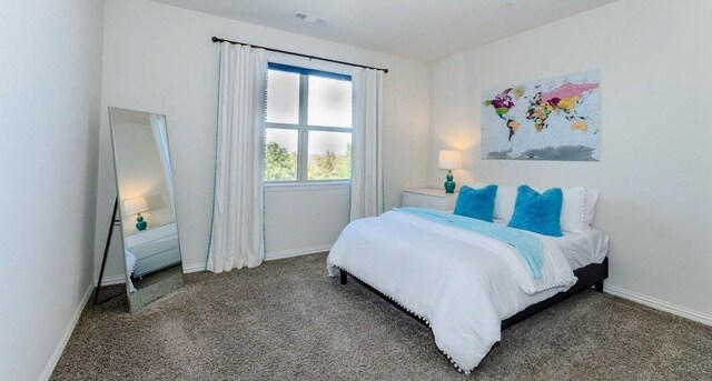 carpeted bedroom featuring baseboards and visible vents