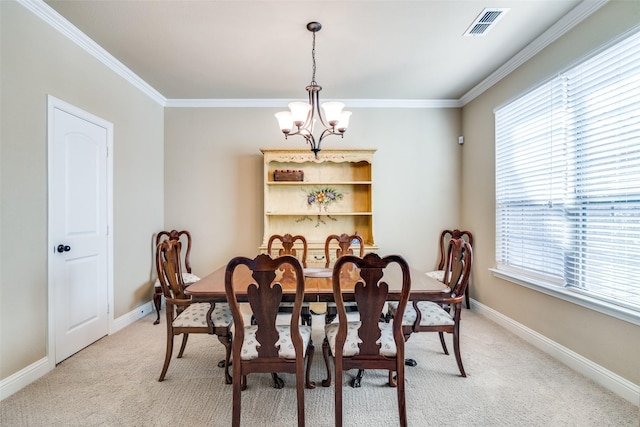 dining space featuring a chandelier, light carpet, crown molding, and visible vents