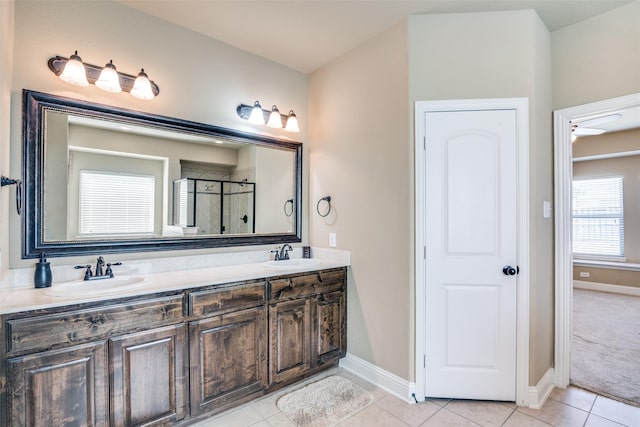 full bathroom featuring double vanity, tile patterned flooring, a sink, and a shower stall