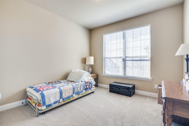 bedroom with carpet floors and baseboards