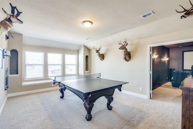 game room with carpet floors, baseboards, visible vents, and a textured ceiling