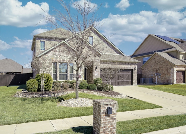 traditional-style house with concrete driveway, brick siding, and a front lawn