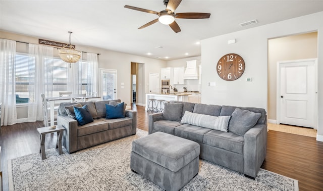 living room with baseboards, visible vents, ceiling fan, light wood-style floors, and recessed lighting