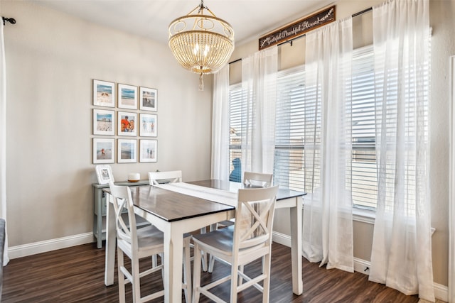 dining room with baseboards, a chandelier, and dark wood-type flooring