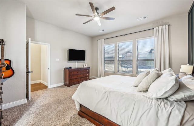 bedroom with carpet floors, visible vents, baseboards, and a ceiling fan