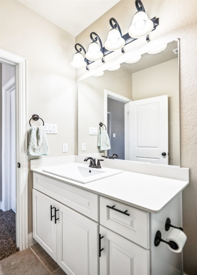 bathroom featuring tile patterned flooring and vanity