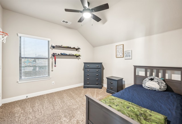 carpeted bedroom with baseboards, visible vents, vaulted ceiling, and a ceiling fan