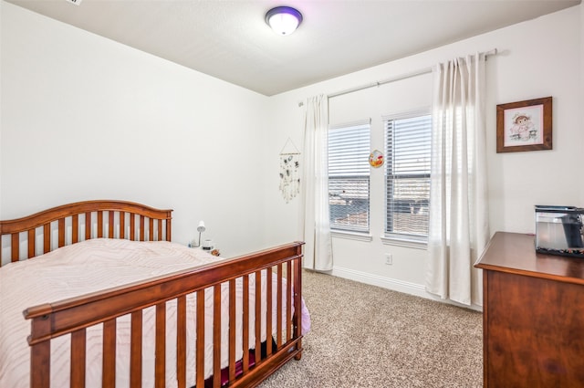 carpeted bedroom with baseboards