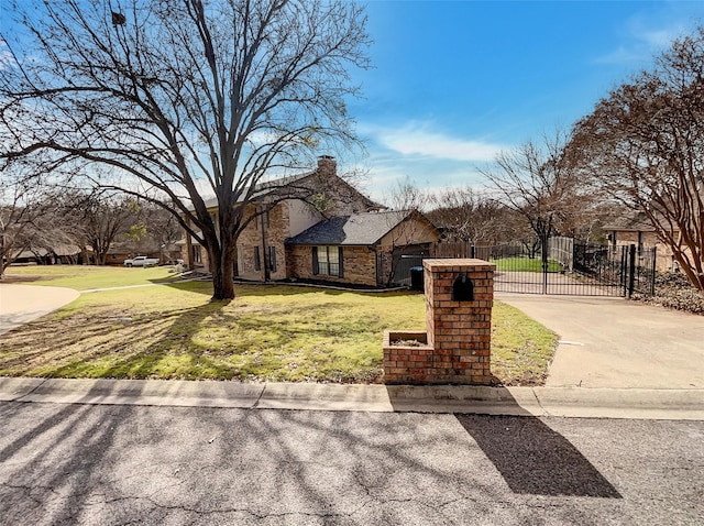 view of front of home featuring brick siding, fence, a gate, a chimney, and a front yard