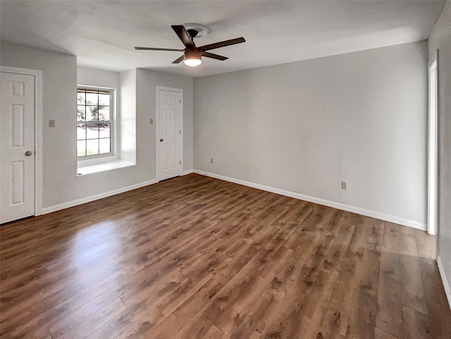 spare room with ceiling fan, baseboards, and wood finished floors