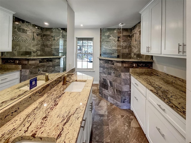 kitchen with a sink, white cabinets, and light stone countertops