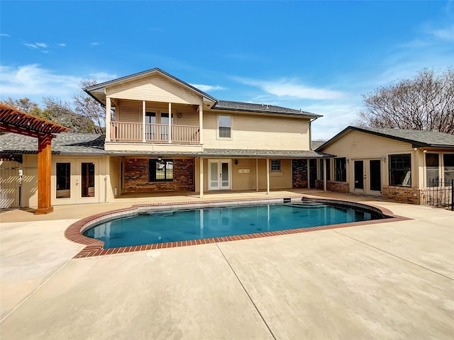 pool with a patio and french doors