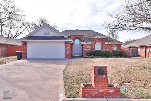 view of front of property with driveway, brick siding, an attached garage, and a shingled roof