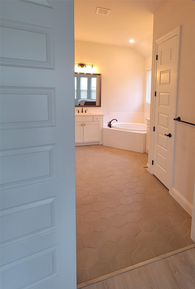 bathroom featuring plenty of natural light, a garden tub, vanity, tile patterned flooring, and recessed lighting