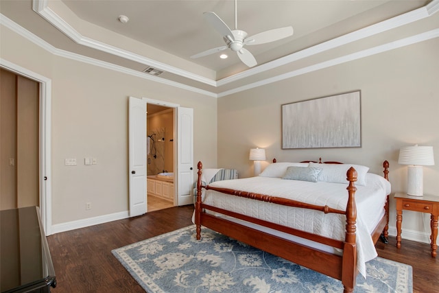 bedroom with a raised ceiling, wood finished floors, visible vents, and ornamental molding