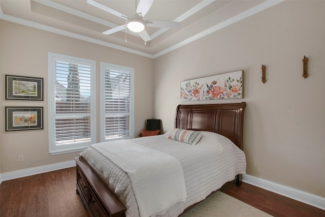 bedroom featuring a tray ceiling, wood finished floors, and baseboards