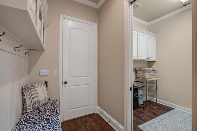 clothes washing area featuring visible vents, crown molding, dark wood-type flooring, and baseboards