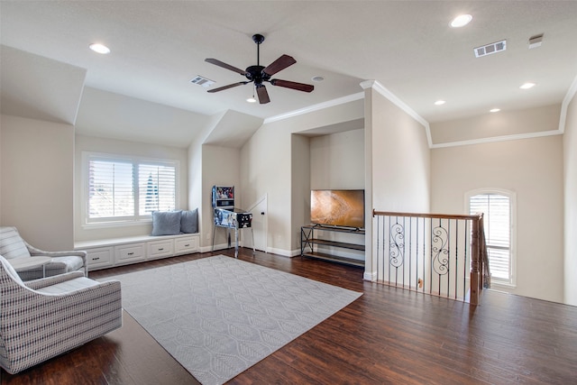 living area with recessed lighting, visible vents, dark wood finished floors, and crown molding