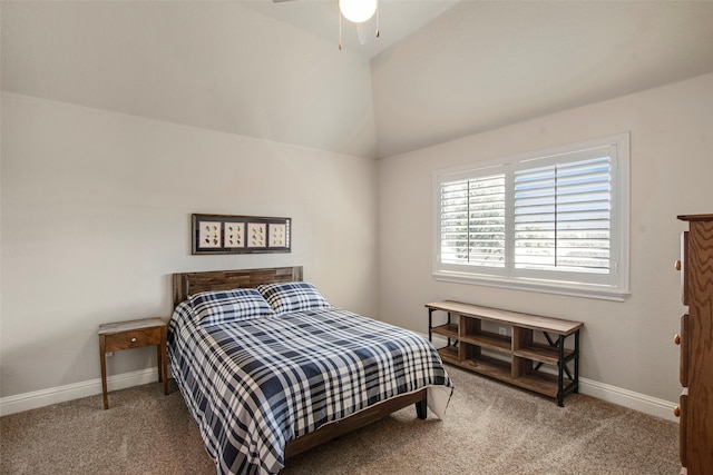 carpeted bedroom featuring baseboards and vaulted ceiling